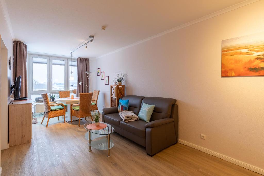 a living room with a couch and a table at Haus Knechtsand, Whg 433 in Cuxhaven