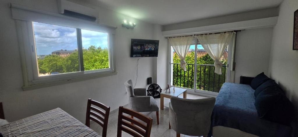 a bedroom with a bed and a table and a window at EdenMDQ-4 in Mar del Plata