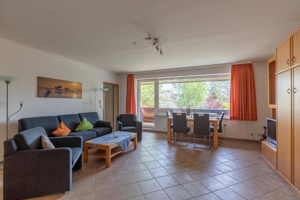 a living room with a couch and a table at Haus Luv und Lee Wohnung 26 in Döse