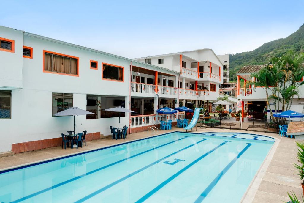 a view of the pool at a hotel with a resort at Hotel Caribe La Vega in La Vega