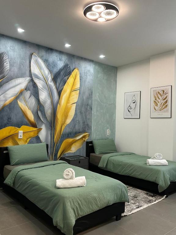 two beds in a room with a mural on the wall at Aura Apartment 2 Herne in Herne