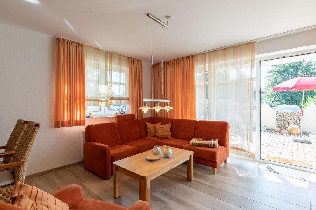 a living room with a couch and a table at Haus Weser, Whg 2 in Döse