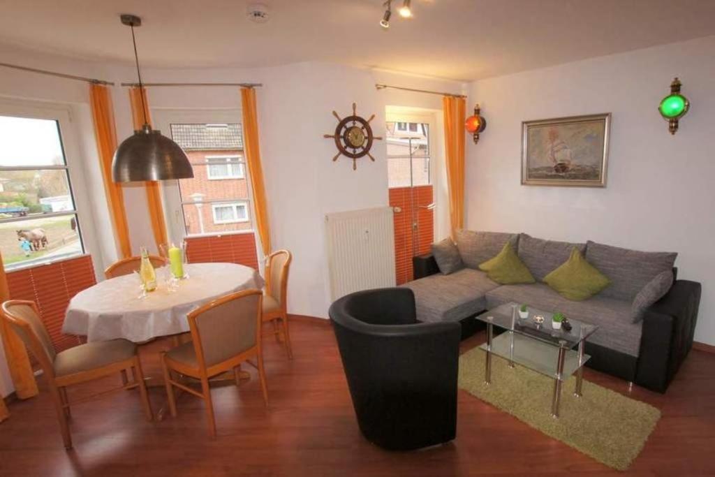 a living room with a couch and a table at Haus Elbe 1, Whg 18 in Cuxhaven