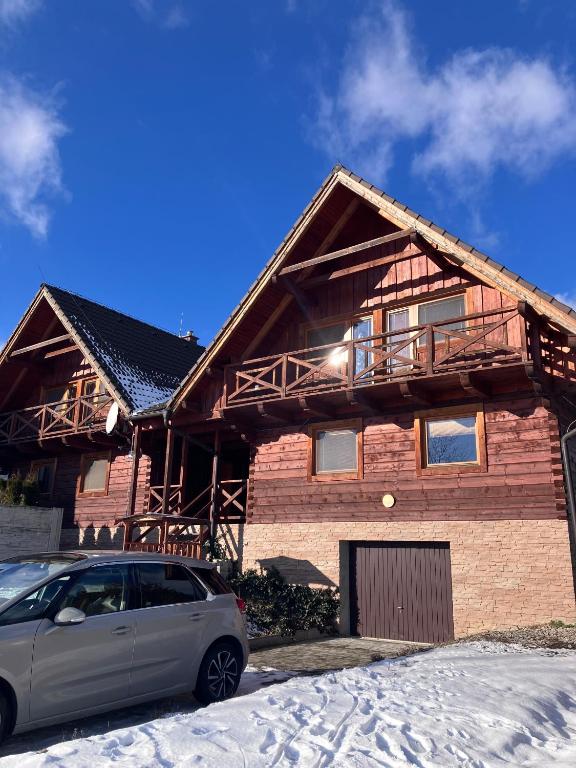 a house with a car parked in front of it at Barbora chata in Nitrianske Rudno