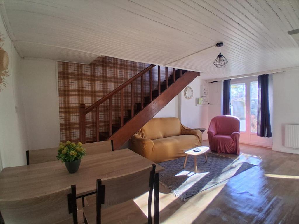 a living room with a staircase and a couch at Maison de l'harmonie à Limoges in Limoges