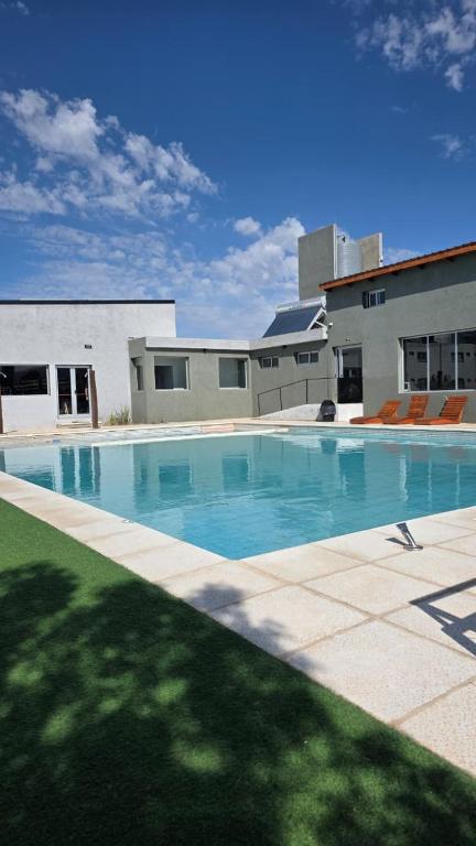 a large swimming pool in front of a building at Complejo Gran Chacha in Tanti