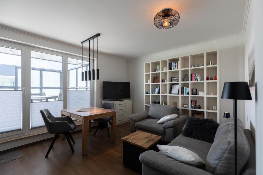 a living room with a couch and a table at Haus Medemsand, Whg 221 in Duhnen