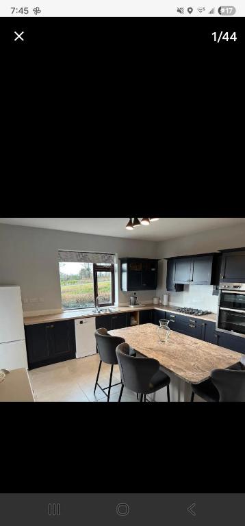 a kitchen with a table and chairs in it at Seaview House in Donegal