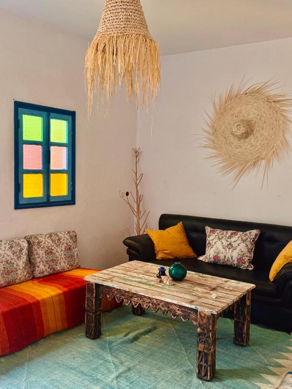 a living room with a couch and a coffee table at Global Surf GuestHouse in Sidi Kaouki