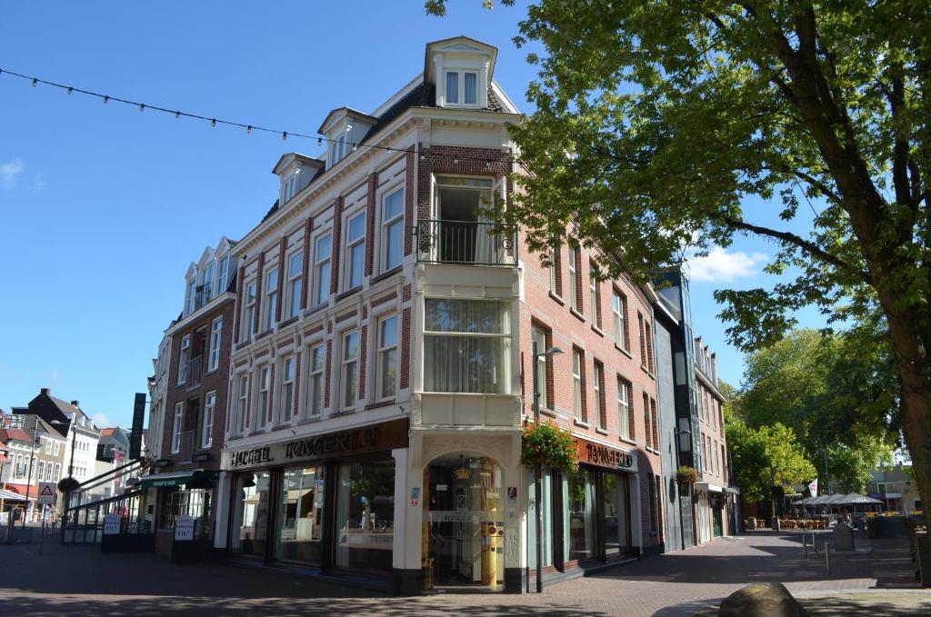 a tall building on a city street at Hotel Tongerlo in Roosendaal