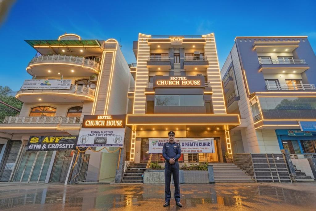 a man standing in front of a building at Hotel Church House - Rohini I Near Metro I Spacious Rooms I Friendly Staff I Most Preferred Hotel In Rohini in Delhi