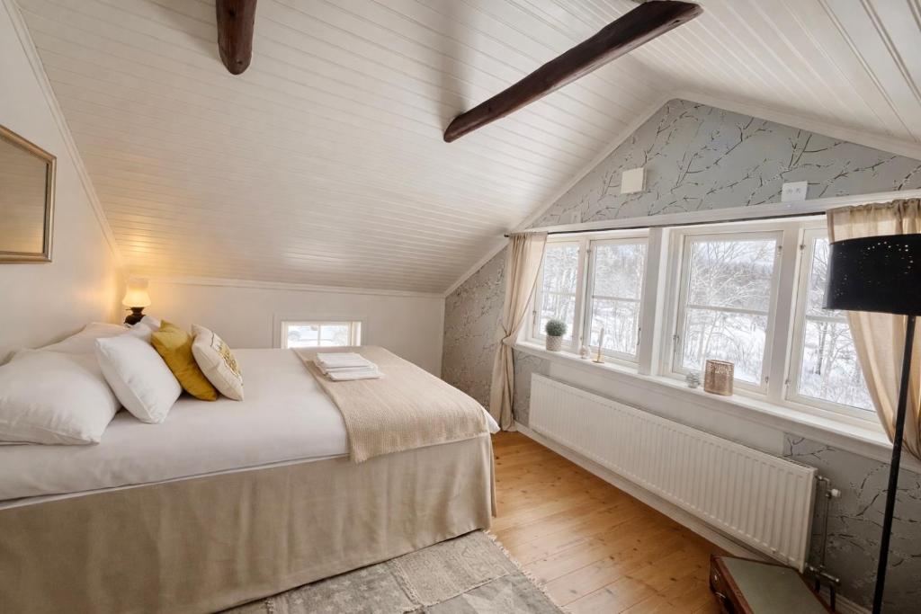 a bedroom with a bed and a window at Vallevägen Country Retreat - Private Pond, Fireplace & Nature 