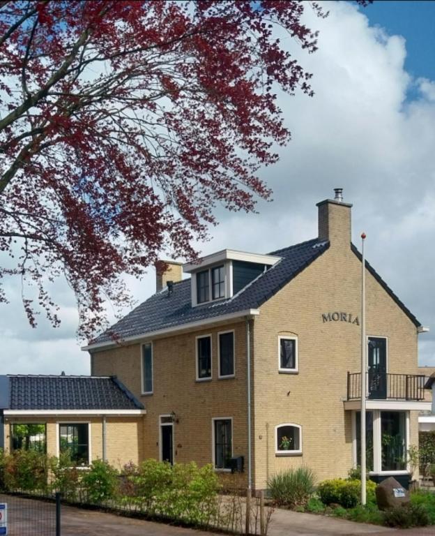 a building with the words molokai on it at B&B Moria in Surhuisterveen