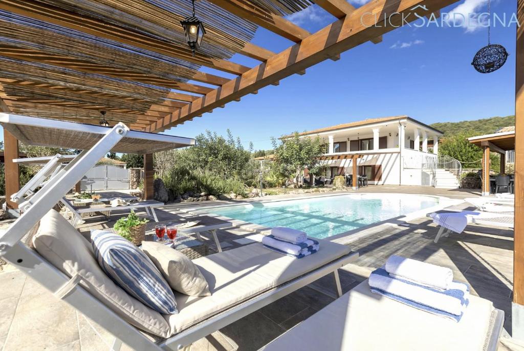 a villa with a swimming pool and a house at Alghero Villa Flamingo Luxury Resort with exclusive pool, gym and SPA in Alghero