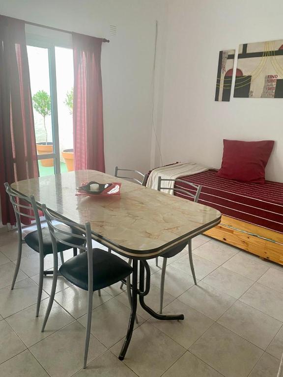 a table and chairs in a room with a bed at Depto 1 in Villa Carlos Paz