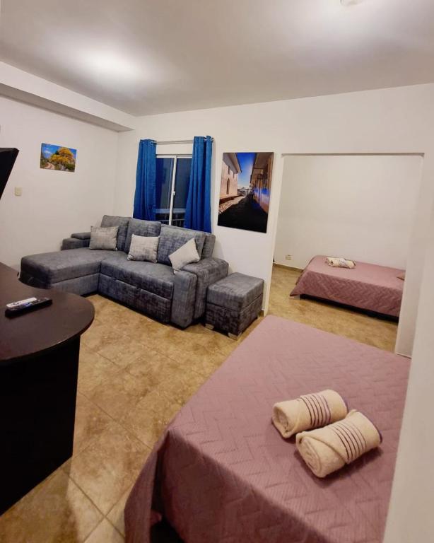 a living room with a couch and a bed at Colonial Travel Popayán in Popayan