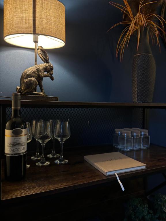 a table with a bottle of wine and glasses at StoneHaven Townhouse in Donegal