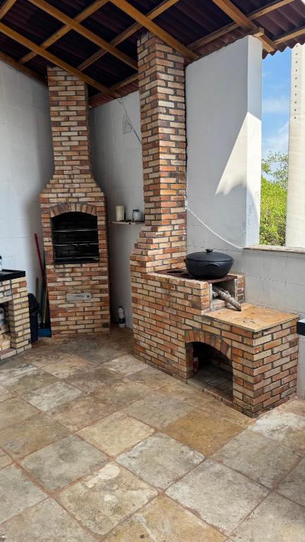 an outdoor kitchen with a brick oven in a patio at Recantodomarsaojose in São José de Ribamar