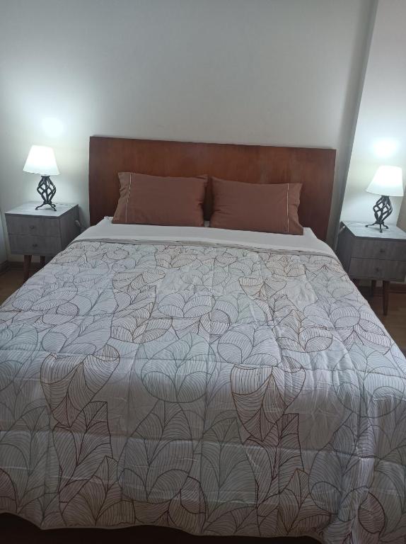 a bedroom with a large bed with two night stands at Miraflores View in Lima