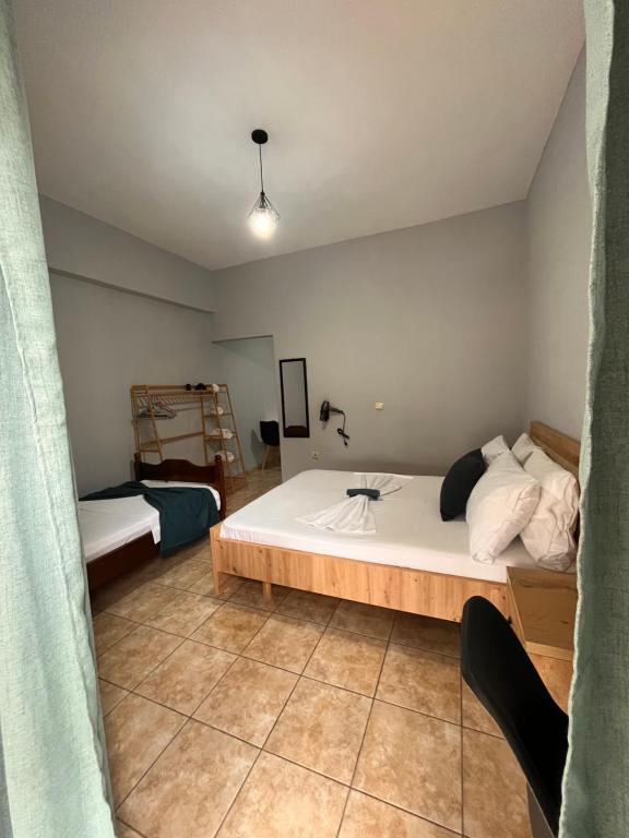 a bedroom with a large white bed in a room at Milto's Rooms in Himare