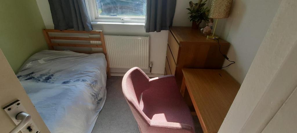 a bedroom with a bed and a desk and a chair at Eighteen in Jesmond