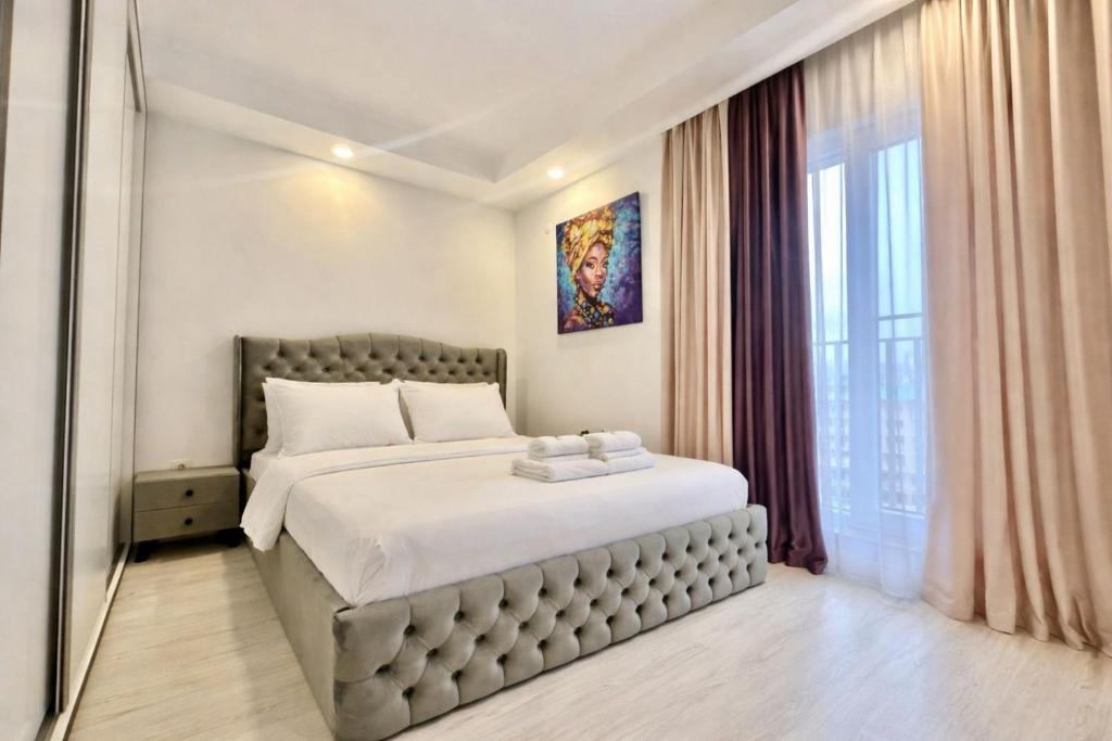 a bedroom with a large bed and a window at Nova Studio Bucharest #pool&parking in Ştefăneştii de Sus