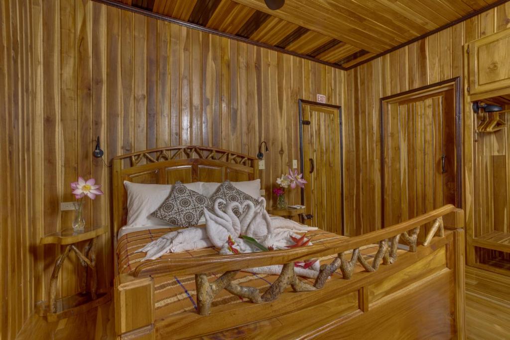 a bedroom with a bed in a wooden room at Tropical Magnolia in Hellgate