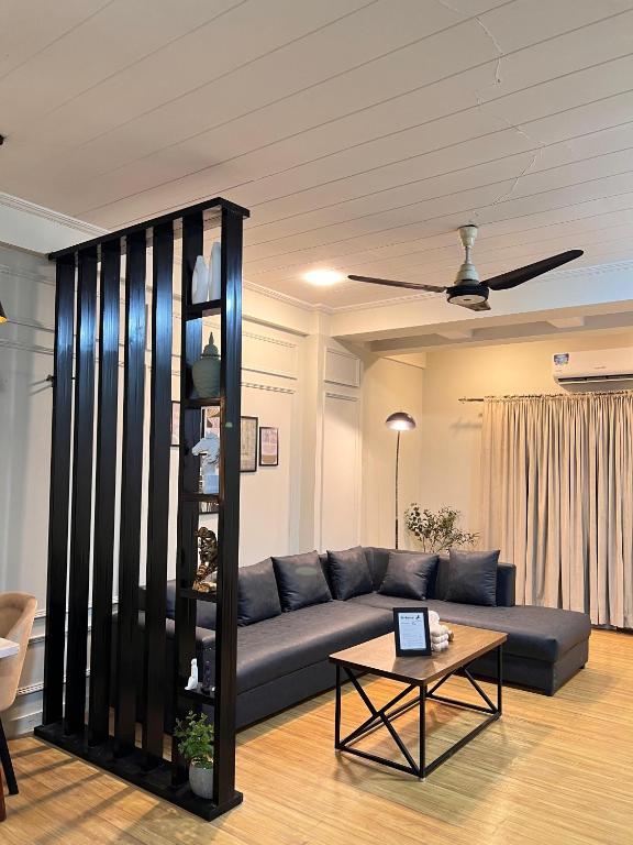 a living room with a couch and a table at Designer 1 bedroom , self check-in , pool & sauna in Rawalpindi