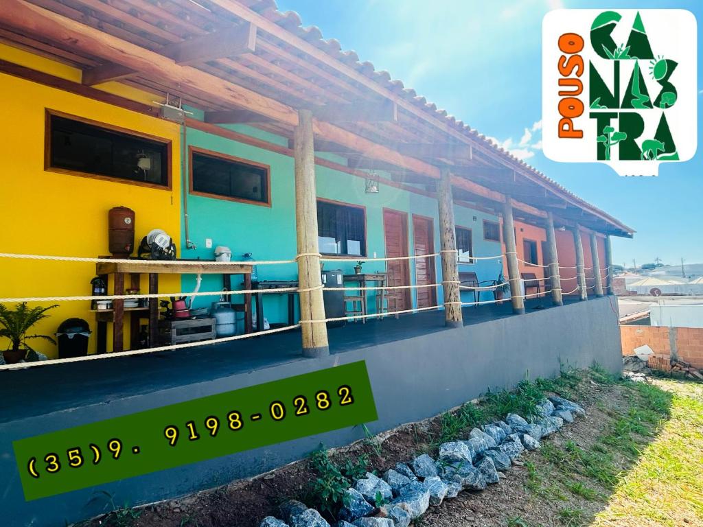 a house with a balcony with a view of the water at Pouso Canastra - Chalés in São João Batista do Glória