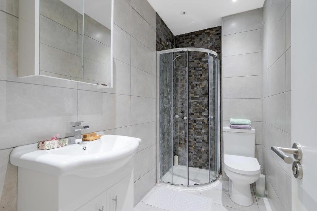 a bathroom with a shower and a sink and a toilet at City Sparrow - Upper Pad Nest in London