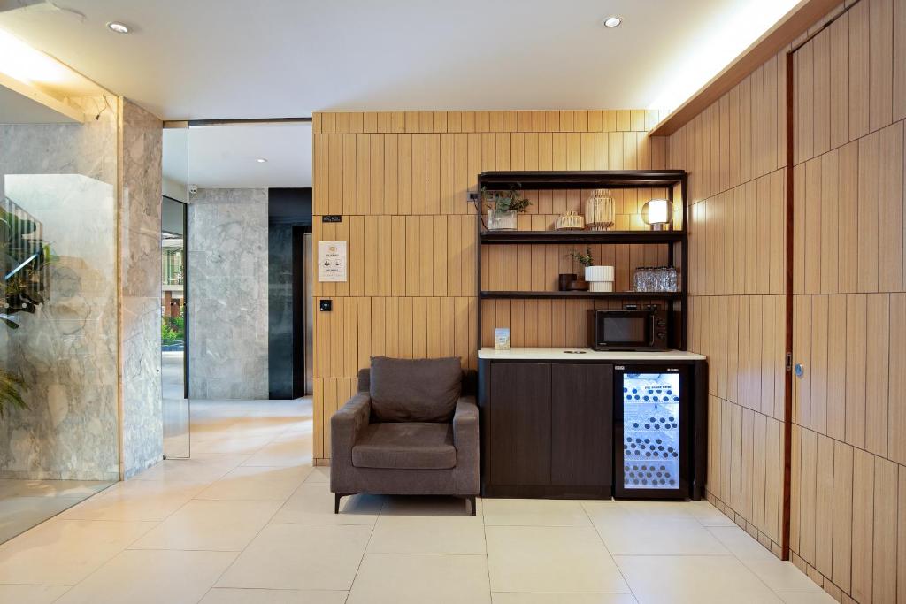 A compact seating nook beside a beverage station, microwave, and minibar refrigerator.