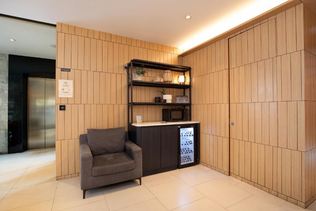 A single-armchair refreshment corner with a microwave and glass-front refrigerator.