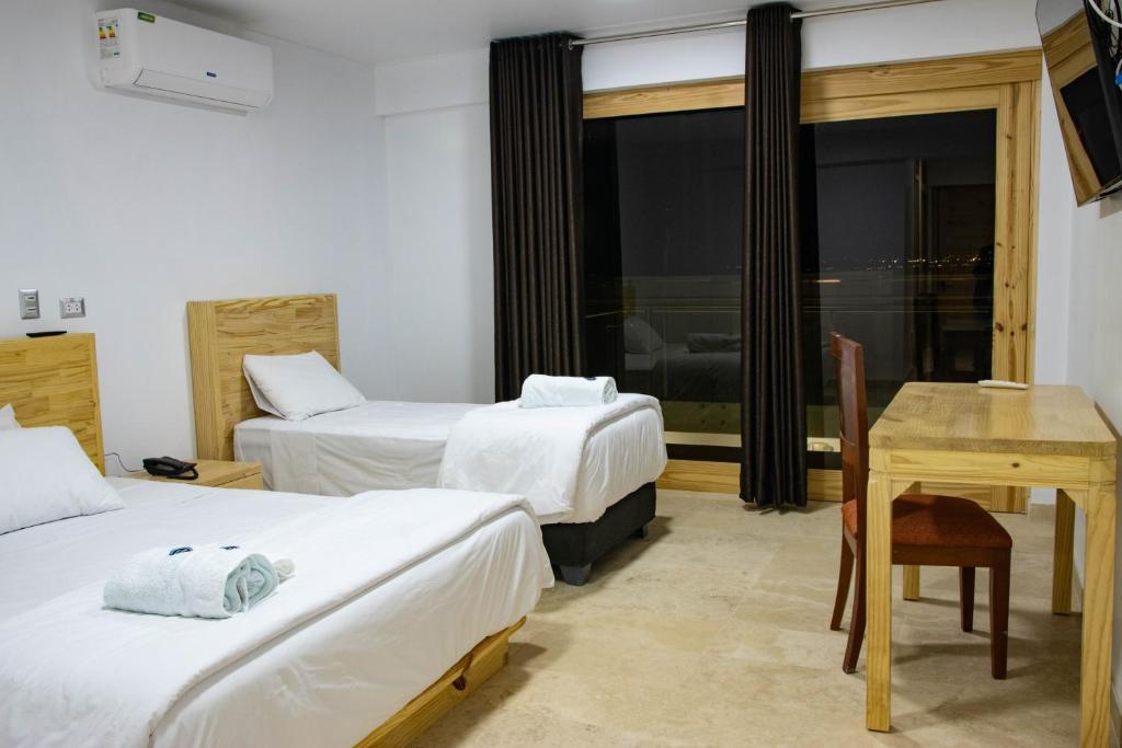 Giường trong phòng chung tại Hotel Boutique La Angostura II