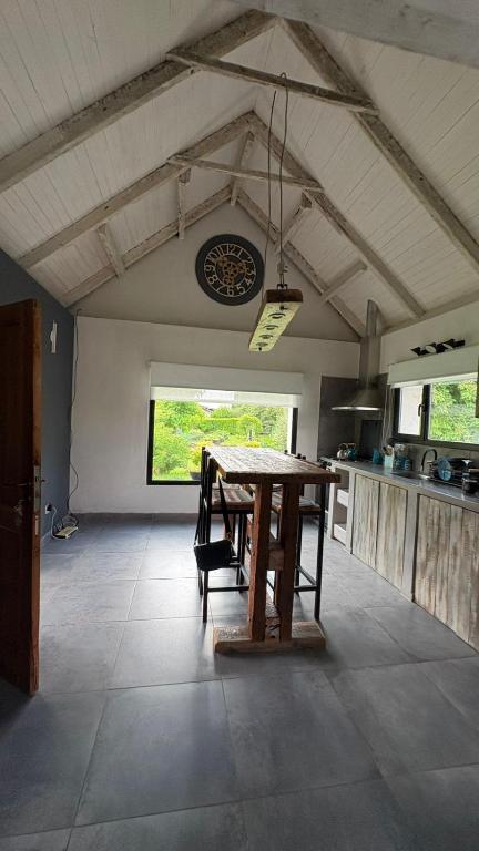 a kitchen with a wooden table in a room at Complejo Los Saucos II in El Hoyo
