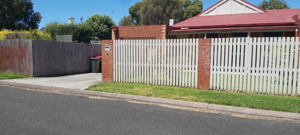 a white fence in front of a house at Margarets Lane in Warrnambool