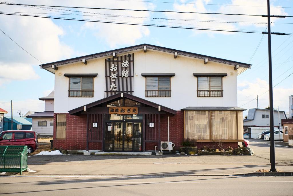 a building on the corner of a street at 旅館おぎた Ryokan Ogita - near Shiraoi Station in Shiraoi