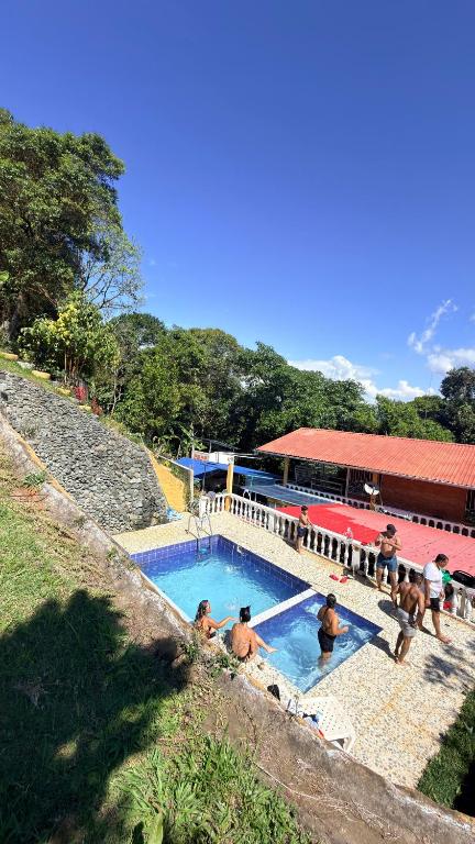 a group of people sitting in a swimming pool at Hostal Casa LUCY in Yumbo