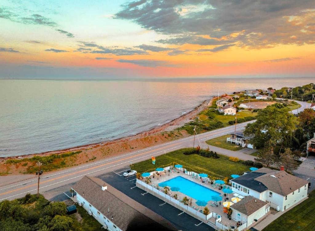 an aerial view of a house and the ocean at Rye Motor Inn - Oceanfront, Walk to Beach in Rye