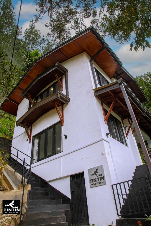 a house with stairs leading up to it at Tin Tin Lodge in Ella