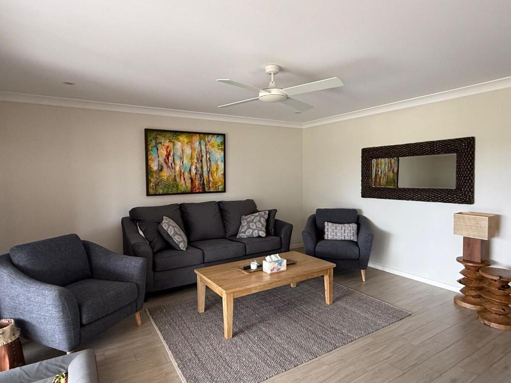 a living room with a couch and a table at Coolamon in Ballina