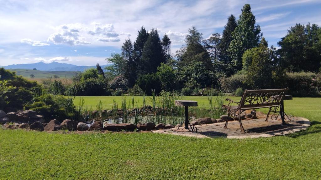 a park bench sitting in the middle of a field at Dunford's Loft in Himeville