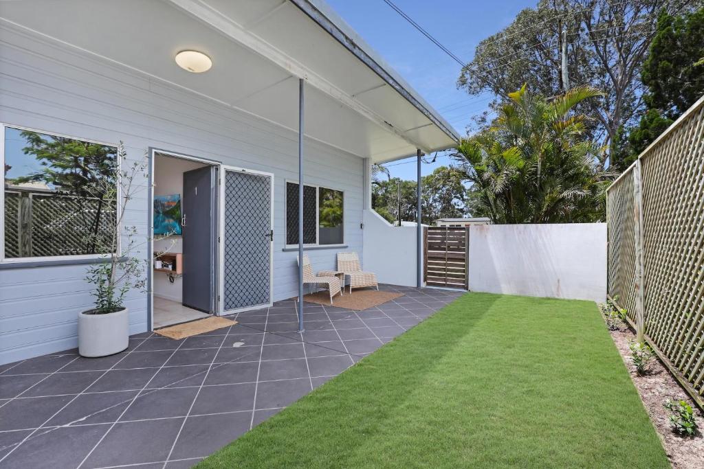 an empty backyard with a patio and grass at 1/24 Birch Street in Amity Point