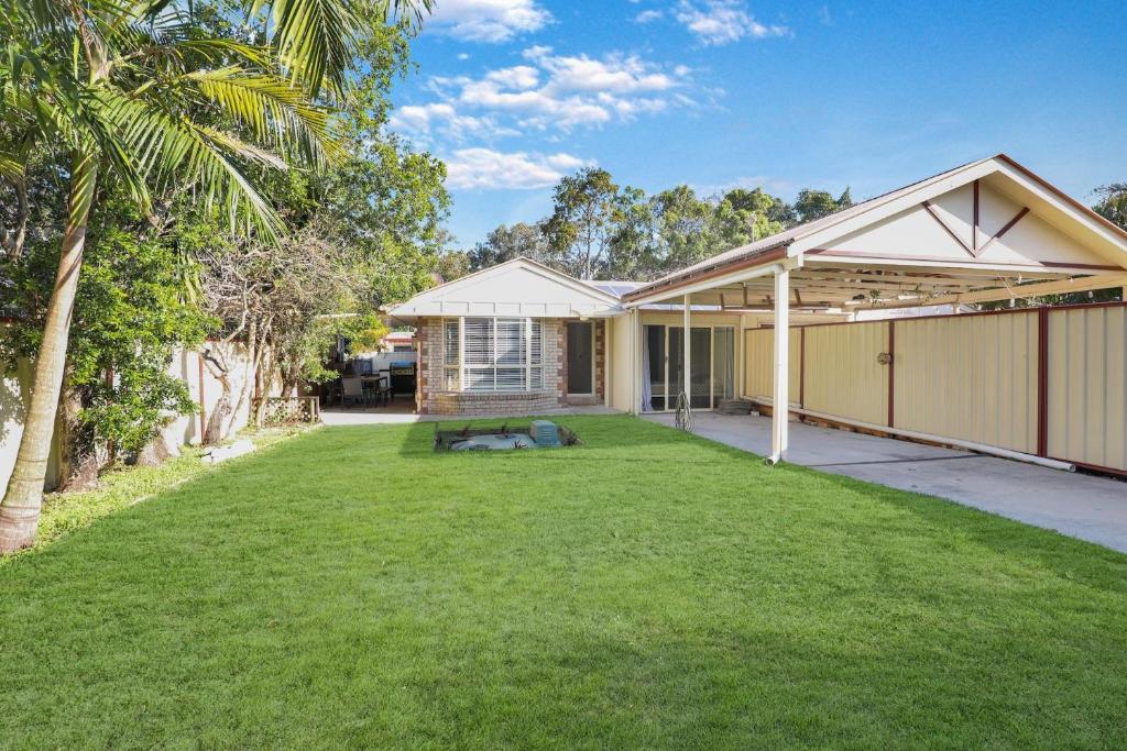 a backyard of a house with a lawn at Barefoot Haven in Amity Point