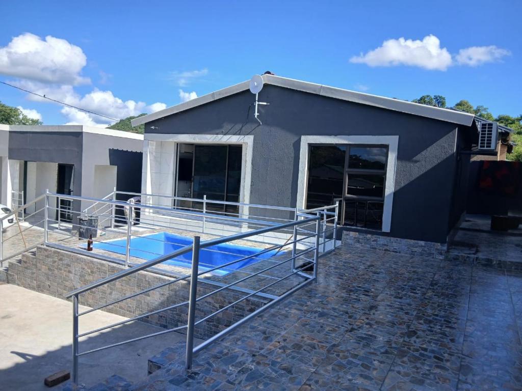a house with a swimming pool in front of it at Baraba's guest house in Nelspruit