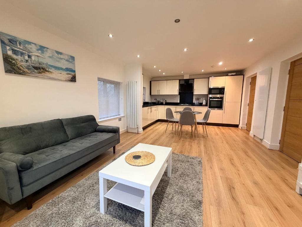 a living room with a couch and a table at Sleek Modern 2BDR Flat in Charming Pinner in Northwood