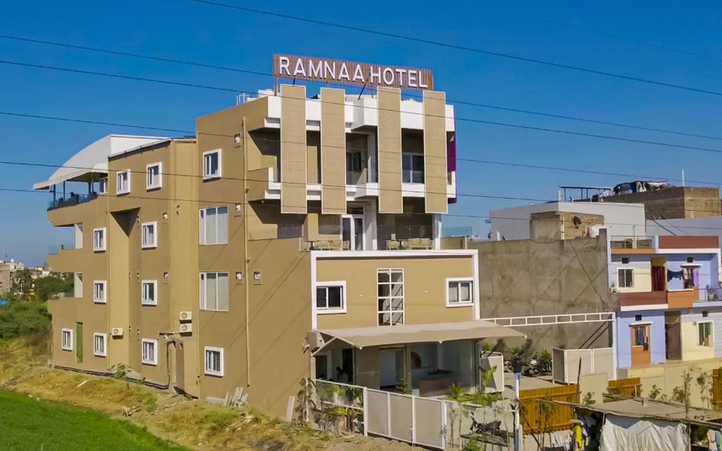a building with a sign on top of it at Ramnaa Hotel in Jāmb