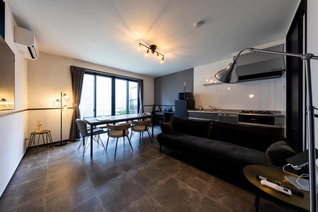 a living room with a couch and a table at AMP FLAT Marron Hontosu in Tosu
