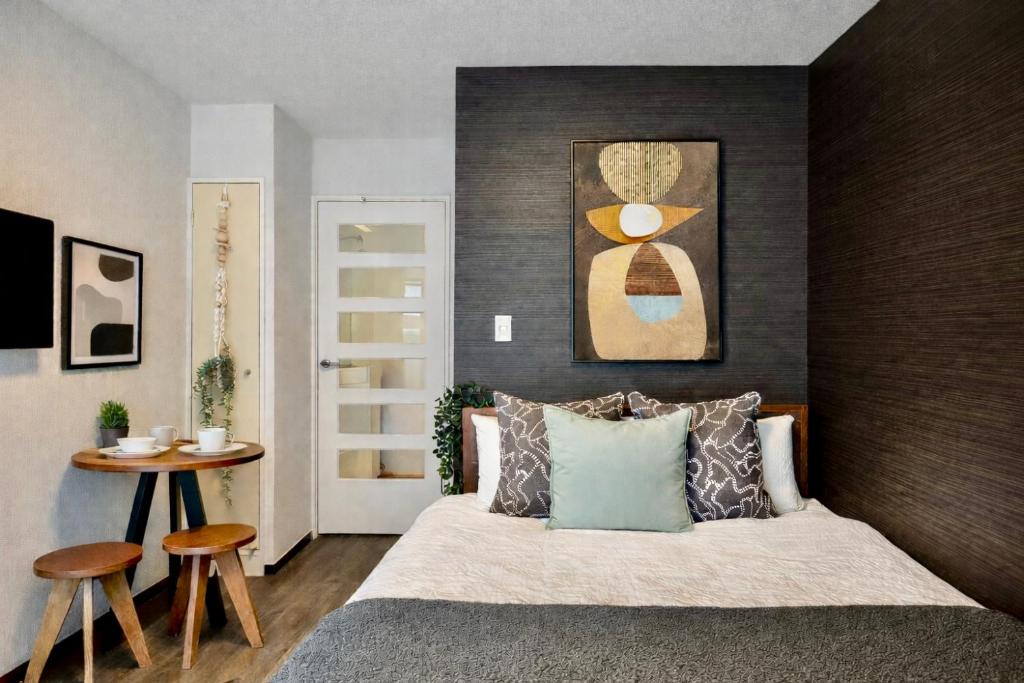 a bedroom with a large bed with a wooden headboard at Hachioji House 201 Apartment in Hachioji