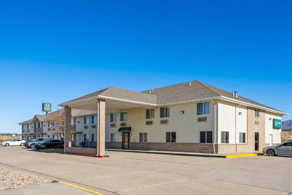 a building on a street with cars parked in a parking lot at Quality Inn Beaver I-15 in Beaver
