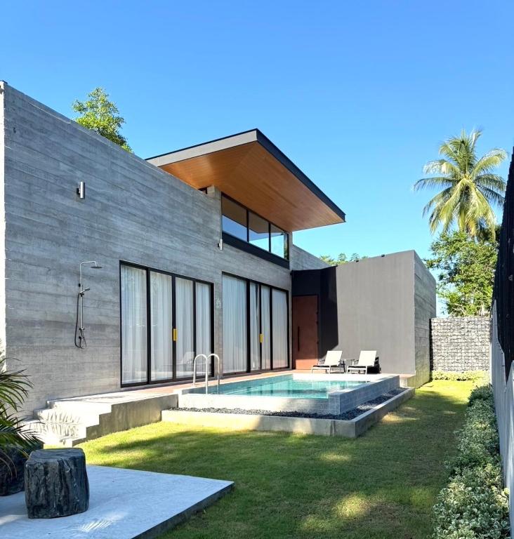 a house with a swimming pool in the yard at Balance Village - exclusive villa with facility offered a full sense of privacy and resort style swimming pool in Ko Phangan